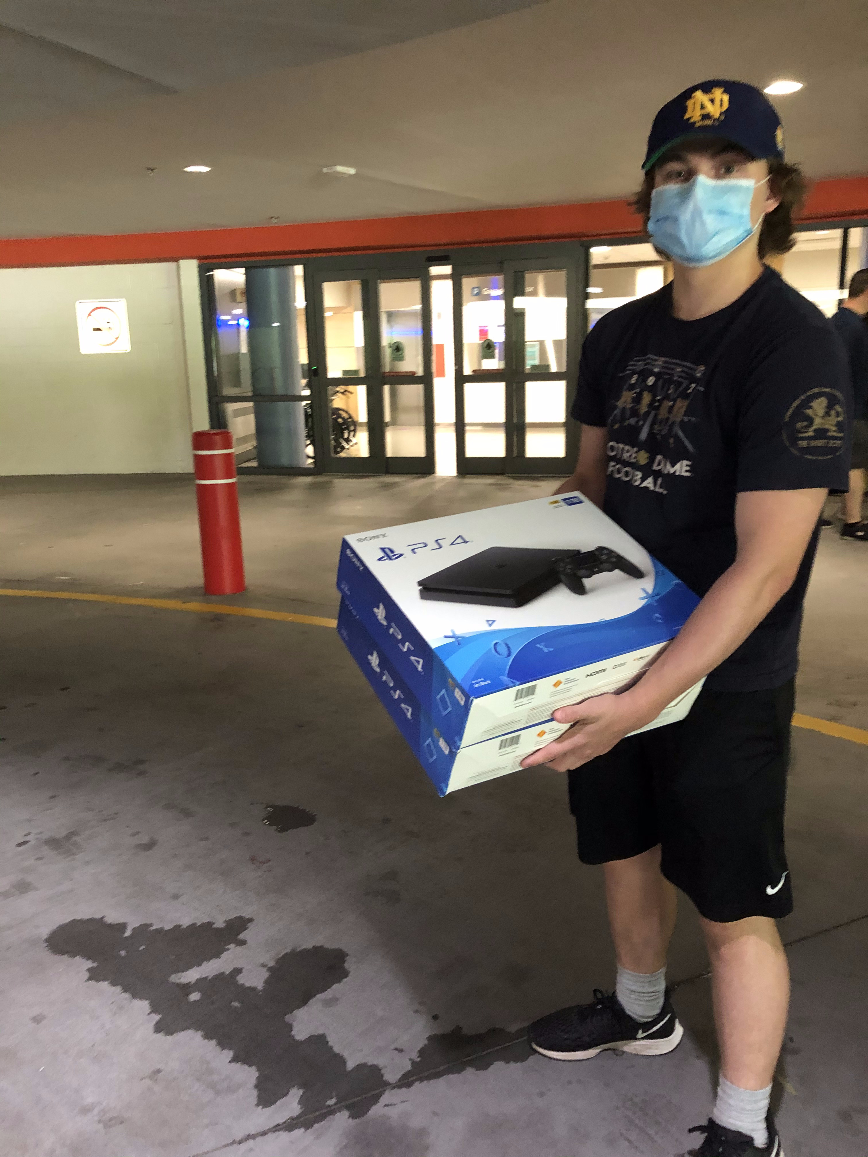Nick donating 2 PlayStations outside the hospital